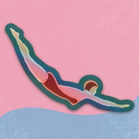 This is a sticker of the image of the female diver which sits on top of the Museum of Neon Art. The diver wears a red one piece swimsuit and a red swimming cap. The background is a turquoise blue. This sticker is die cut around the body of the diver and it is made of durable holographic material. So, it's really shimmery and fun. It measures about 3 1/2 inches wide and about 1/2 inch tall. Very striking or a small sticker. 